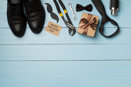 Happy Father's Day inscription with different gifts on wooden background, top view.の写真素材