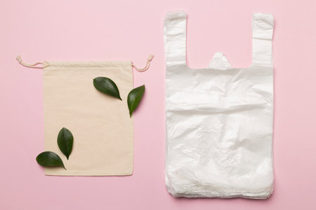 Plastic and fabric bag on color background, top view. Biodegradable products conceptの写真素材