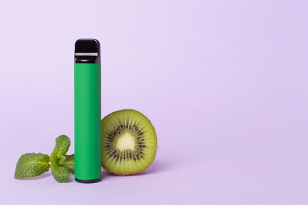 Disposable electronic cigarette and fruit on color backgroundの写真素材