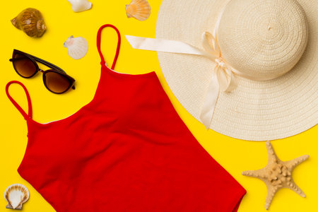 Beautiful red bikini and accessories on color background, top view.の写真素材