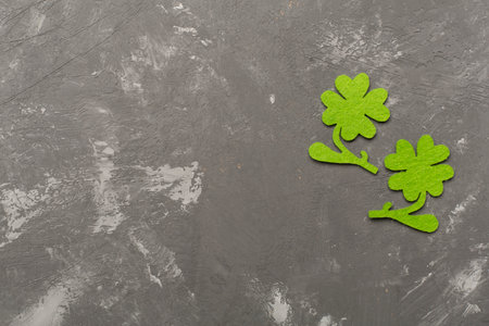 Felt clover on concrete background, top view. St. Patricks day concept