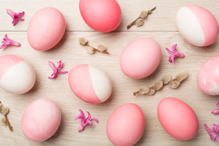 Pink Easter eggs with decor on wooden background, top viewの写真素材