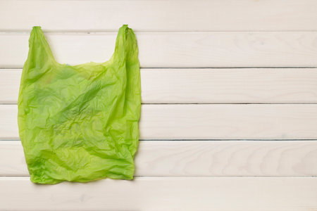 Disposable plastic bag on wooden background, top view.の写真素材