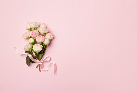 Small bouquet with rose flowers on color background, top view.の写真素材