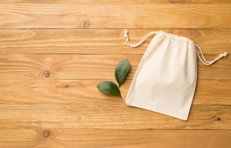 Small eco sack on wooden background. Top view.の写真素材