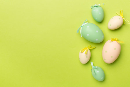Cute easter eggs on color background, top viewの写真素材