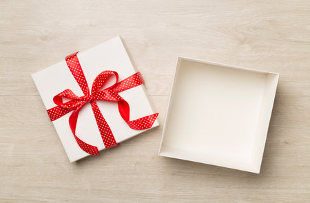 Open gift box on wooden background, top viewの写真素材