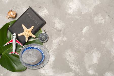 Traveler accessories on concrete background, top view