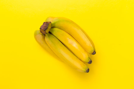 Fresh bananas on color background, top viewの写真素材