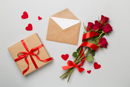 Valentines day gifts with red roses on color background, top viewの写真素材