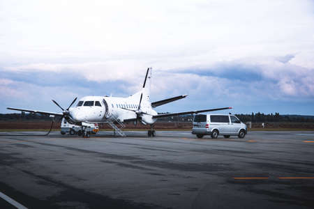 Airplane at the apron with passenger vanのeditorial素材