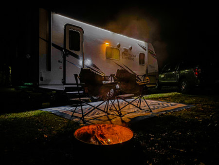Camper rv camping with bonfire at night. Camping in motor home.の写真素材