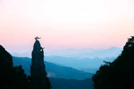 a silhouette of a mountain landscape at sunsetの写真素材