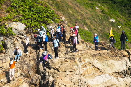 Unidentified tourists climbing on the cliff to see the beauty of the sea.の写真素材