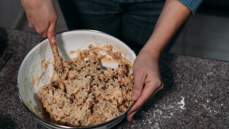 WHITE HANDS MIXING INGREDIENTS FOR COOKIES