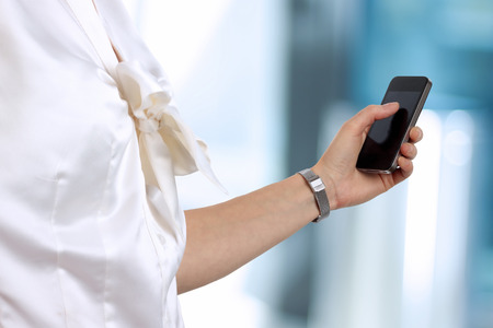 Businesswoman holding  and using the  mobile  smart  phoneの写真素材