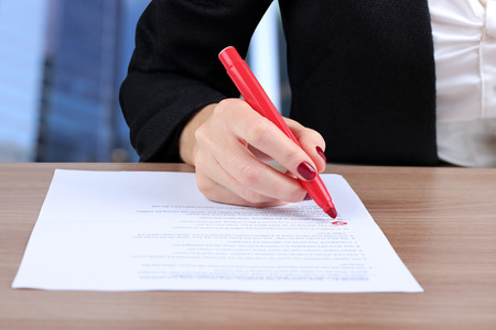 young business woman doing  test (making a decision), sitting  at the tableの写真素材
