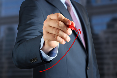 Businesswoman  drawing a virtual  graph by  a red penの写真素材