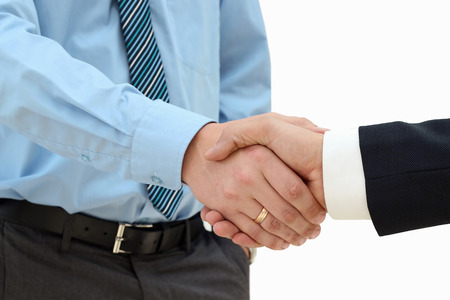 Close-up image of a firm handshake  between two colleagues on a white backgroundの写真素材