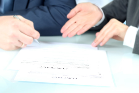 businesss persons signing a contract