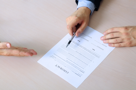 two colleagues is signing a contract, business meeting in the officeの写真素材