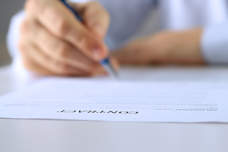 Businessman is signing a contract, business contract detailsの写真素材
