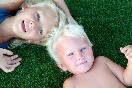 smiling little  girls  on a grassの写真素材