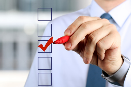 Businessman  making vote  by  a red  penの写真素材