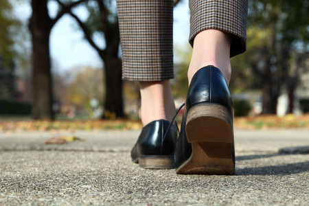 elegant woman in fashion trousers going in a classic fashion bootsの写真素材