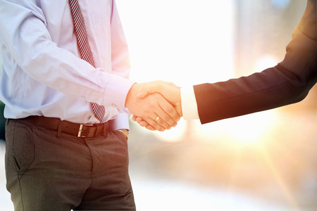 Close-up image of a firm handshake  between two colleagues outsideの写真素材