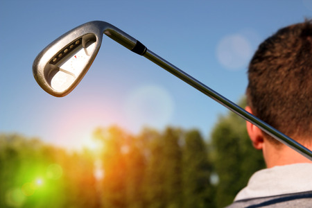 Golf player holding a golf club in golf courseの写真素材