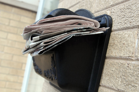 A pile of newspapers in a boxの写真素材