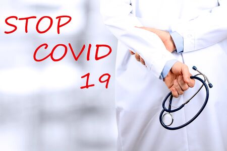 Stop Covid - 19. Doctor is standing with  a stethoscopeの写真素材