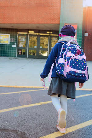 School girl is going to school with backpackの写真素材