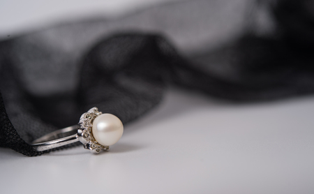 a pearl ring on the lace fabricの写真素材