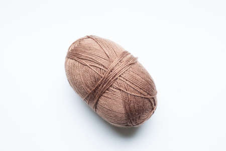 brown skein of yarn on a white background.