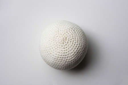 white knitted ball on a white background.の写真素材