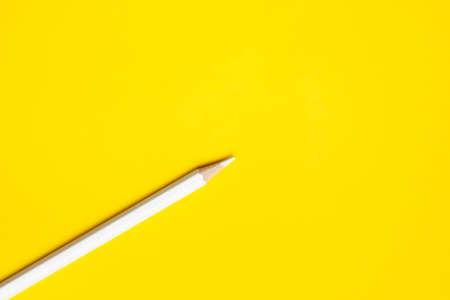 diagonal white sharp wooden pencil on a bright yellow background, isolated, copy space, mock upの写真素材