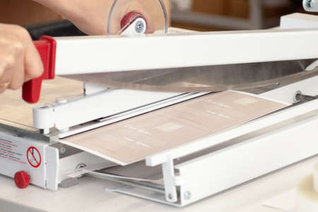 close-up manual guillotine knife blade for paper cuts laminated leaflet, flyersの写真素材