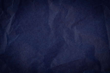 top view of empty crumpled wrinkled tissue paper dark blue color with vignetteの写真素材