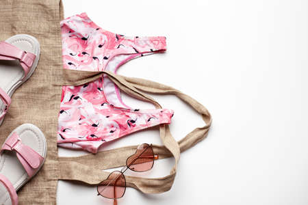 Summer fashion girl clothing and accessories on the left with white background. Flat lay, top view