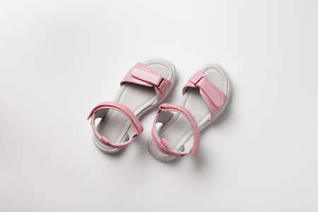 Pink insulated sandals. Childrens pink sandals with white soles and  fasteners isolated on a white background. Fashionable childrens shoes for childrenの写真素材