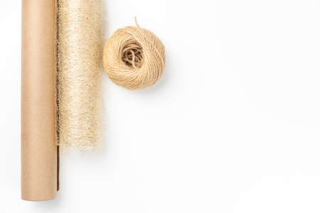 frame or gift card with supplies for gift wrapping with roll of craft paper, decorative mesh and jute rope on white isolated backgroundの写真素材