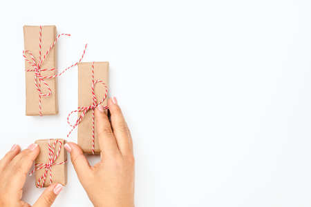 christmas banner with female hand holding gift boxes and with copy space on white isolated...