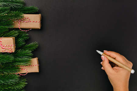 christmas card with woman hand and copy space on black isolated backgroundの写真素材