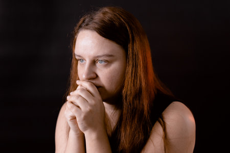 Bewildered young woman thoughtfully looking away. Meditative serious person thinking. Feelings, thoughts in head.の写真素材