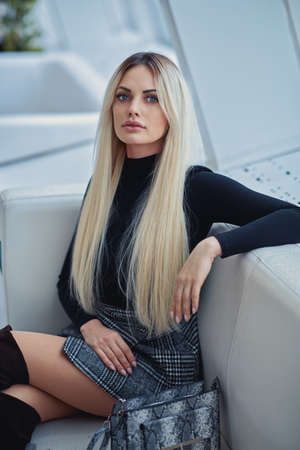 Beauty blonde girl in the cafe in style clothesの写真素材