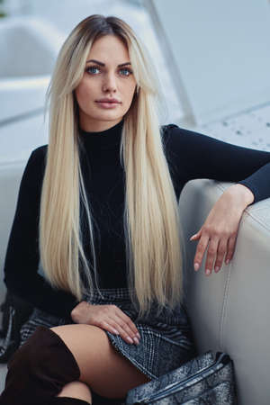 Beauty blonde girl in the cafe in style clothesの写真素材
