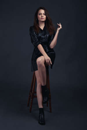 Young brunette girl poses in style clothesの写真素材