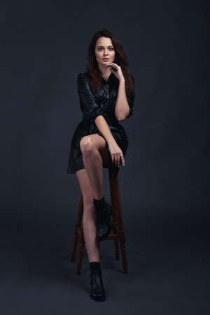 Young brunette girl poses in style clothesの写真素材